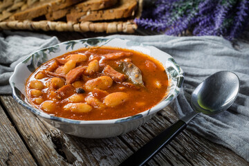 Beans with tomato sauce, bacon and sausage.