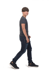 portrait of a teenage side view walking on white background, looking at camera