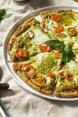 Fototapeta na wymiar Homemade Green Pesto Pizza