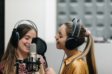 Two women singing at sutdio