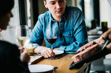 Dining patrons learning about the days meat cuts