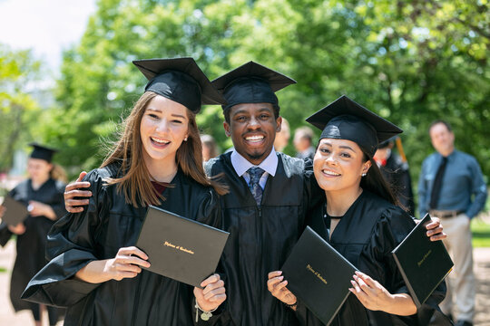 Grad: Three Friends Smile For Camera With Diploma
