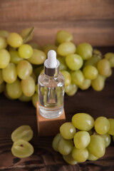 Cold pressed grape oil. Organic bio care products with natural ingredients. Close-up grapes and copy space. Halved grapes and grape seeds.