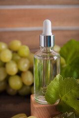 Cold pressed grape oil. Organic bio care products with natural ingredients. Close-up grapes and copy space. Halved grapes and grape seeds.