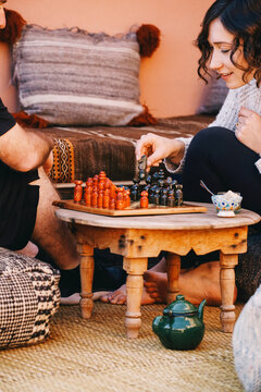 Couple Playing Chess on Boho Rooftop