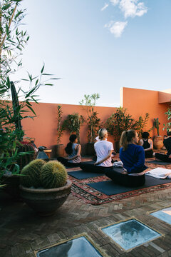 Young People Doing Yoga on Sunny Roof