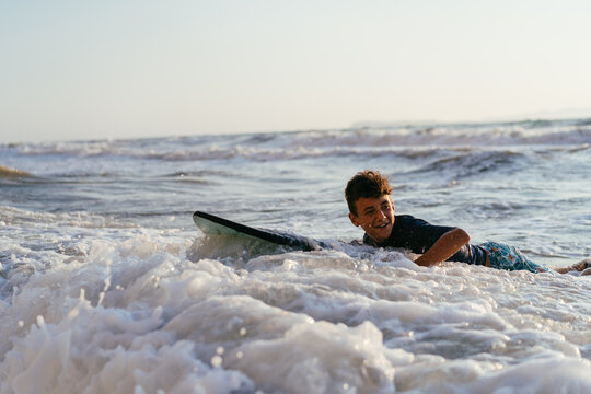 Boy surfing at the ocean