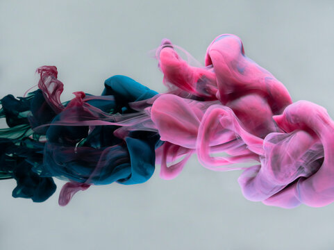 Abstract muted blue and pink colored clouds in water