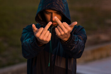 Aggressive bad man showing middle finger, fuck sign at camera. Go away from here