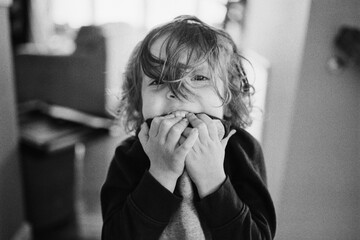 Portrait of a preschooler chewing his shirt