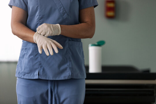 Exam: Nurse Puts On Vinyl Gloves For Safety