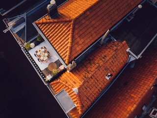 Dining table ready on a balcony of an old house.