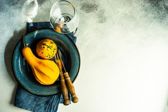 Autumnal table setting with mini pumpkin