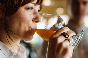 Woman drinking craft beer from a goblet