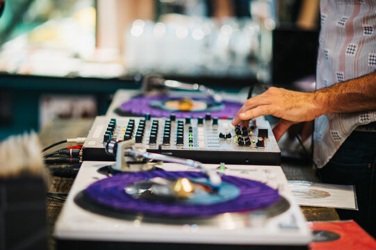 DJ spinning vinyl records at a coffee shop