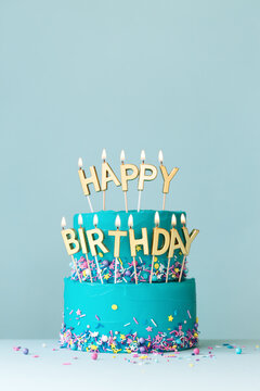 Turquoise birthday cake with golden candles