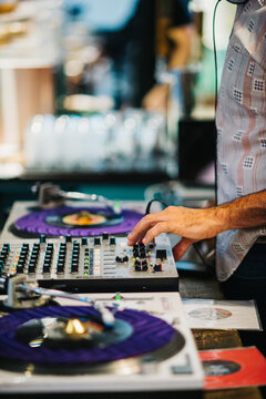 DJ spinning vinyl records at a coffee shop