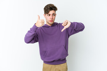 Young caucasian man isolated on white background showing thumbs up and thumbs down, difficult choose concept