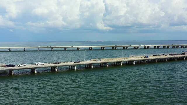 Aerial video cars parked on the Sunshine Skyway Fishing Pier Tampa Bay