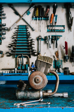 Motorbike engine on bench.