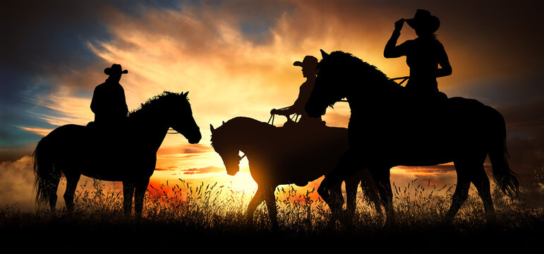 Three cowboys at sunset