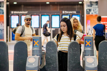 going through the turnstile at train station