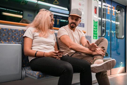 unhappy couple on subway