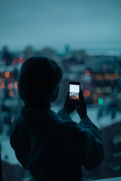 young woman near the window with cell phone