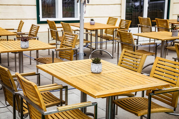Nobody in street cafe because of Coronavirus COVID-19 impact quarantine. No people. Empty restaurant and cafeteria tables.