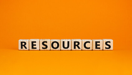 Wooden cubes with word 'resources'. Beautiful orange background. Business concept. Copy space.