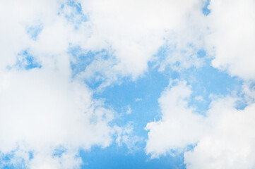 Bright blue sky background with tiny clouds. Sunny day