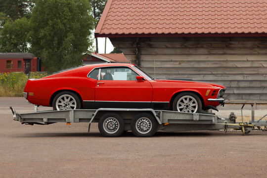 Retro sport classic car on a flatbed truck. Car carrier trailer.