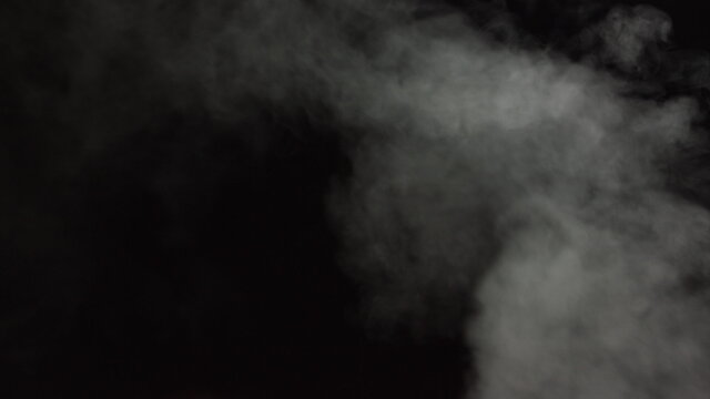 Soft Fog in Slow Motion on Dark Backdrop. Realistic Atmospheric Gray Smoke on Black Background. White Fume Slowly Floating Rises Up. Abstract Haze Cloud. Animation Mist Effect. Smoke Stream Effect 4K © GRAFStock