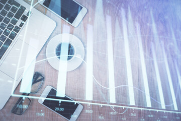 Multi exposure of financial chart hologram over desktop with phone. Top view. Mobile trade platform...