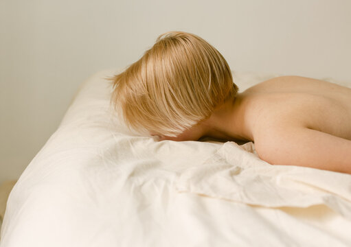 Topless Woman with short hairs Lying On Bed