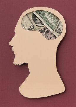 Man head with a brain with dollars bills