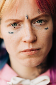 young woman with tattoo on her face