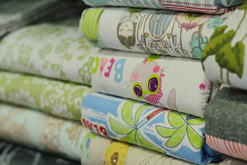 Spain, Pais Vasco, Vitoria, September 2020, variety of bed sheets and blankets in store. Variation of linen is arranged for sale