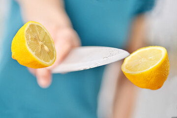 Yellow lemon. Slicing fruit with a knife in the air.