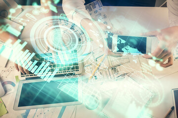 Double exposure of man and woman working together and business theme hologram drawing. Computer background. Top View.