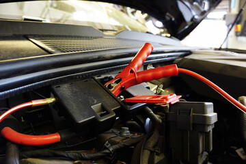 The red terminal is connected to a special connector of the car for charging the battery. 