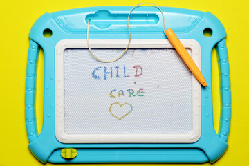 toy blackboard with child care message flat lay