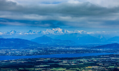 Image of snowcapped Mont Blanc Massif and Leman Lake seen from Jura Mountains in France.