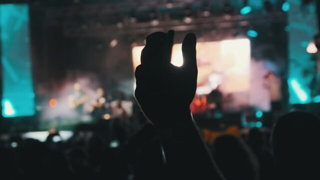 Male with Smartphone in Hand Making Video at Live Rock Concert. Slow Motion
