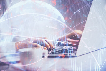 Double exposure of woman hands working on computer and forex graph hologram drawing. Financial analysis concept.
