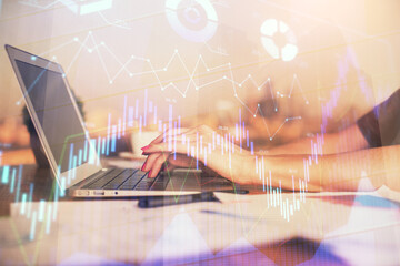 Double exposure of businesswoman hands typing on computer and forex chart hologram drawing. Financial analysis concept.