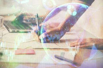 Multi exposure of woman hands typing on computer and financial chart hologram drawing. Stock market analysis concept.