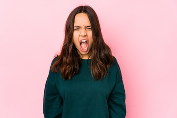 Fototapeta premium Young mixed race hispanic woman isolated shouting very angry, rage concept, frustrated.