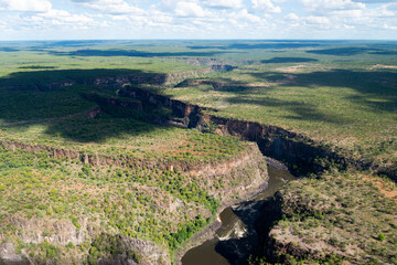 Fototapeta na wymiar Aerial view of Zambezi River in the border of Zimbabwe and Zambia. River between canyons. Zigzag gorges of Victoria Falls.