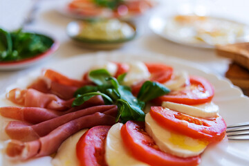 caprese salad with guacamole sauce and tomato - foreground